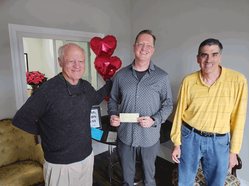 Program Director Bob Hall  (L) and Knight JP Reynolds (R) present a check from Council 6451 to The Rose TLC's   John Featherstone